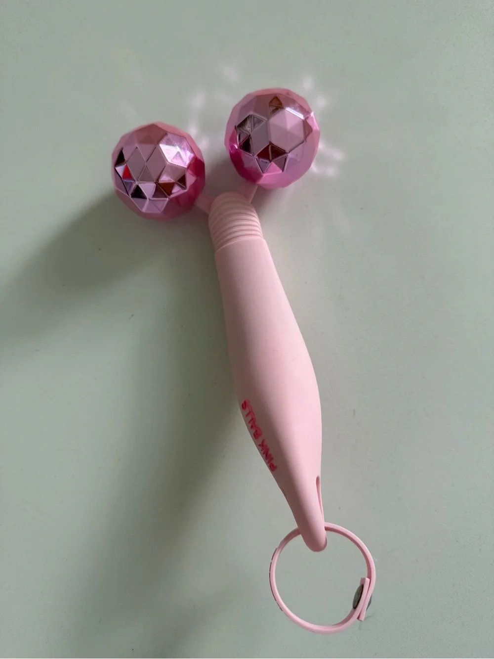 The Skinny Confidential pink balls facial massager